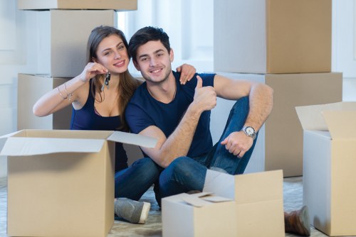 Professional packers organising moving boxes in a Hackney home