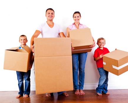 Local moving team handling boxes in a Hackney property with stairs