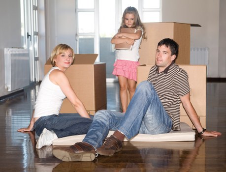 Furniture removal team handling a sofa and table in a Hackney flat